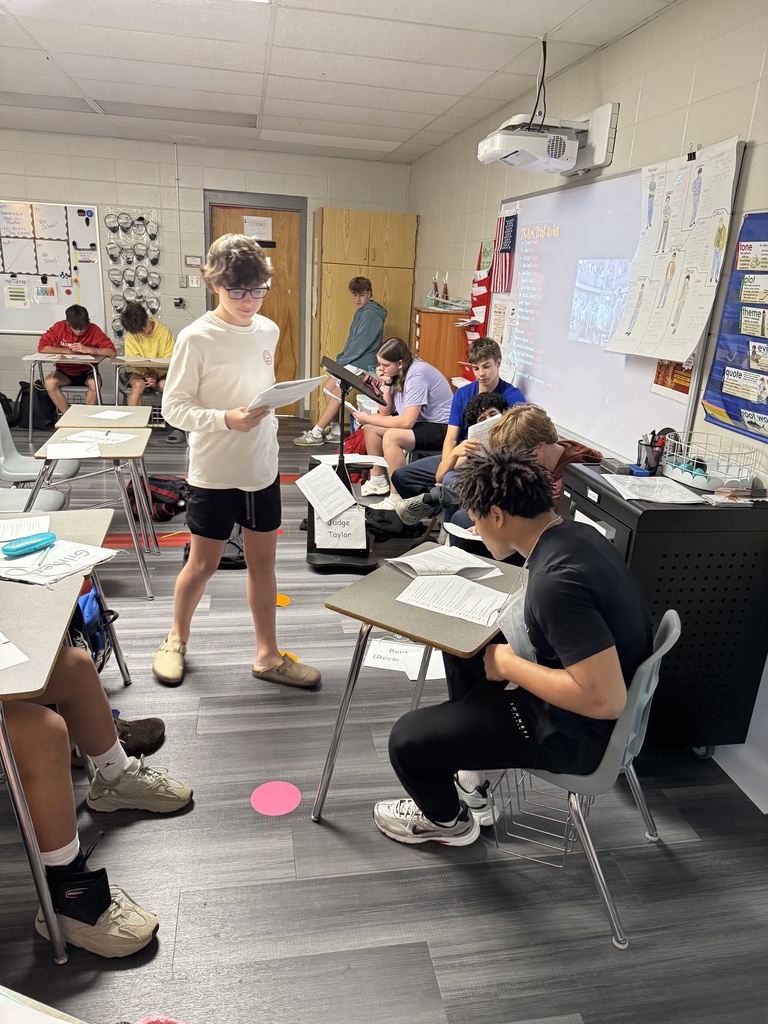 Students acting out a scene from a book in English class