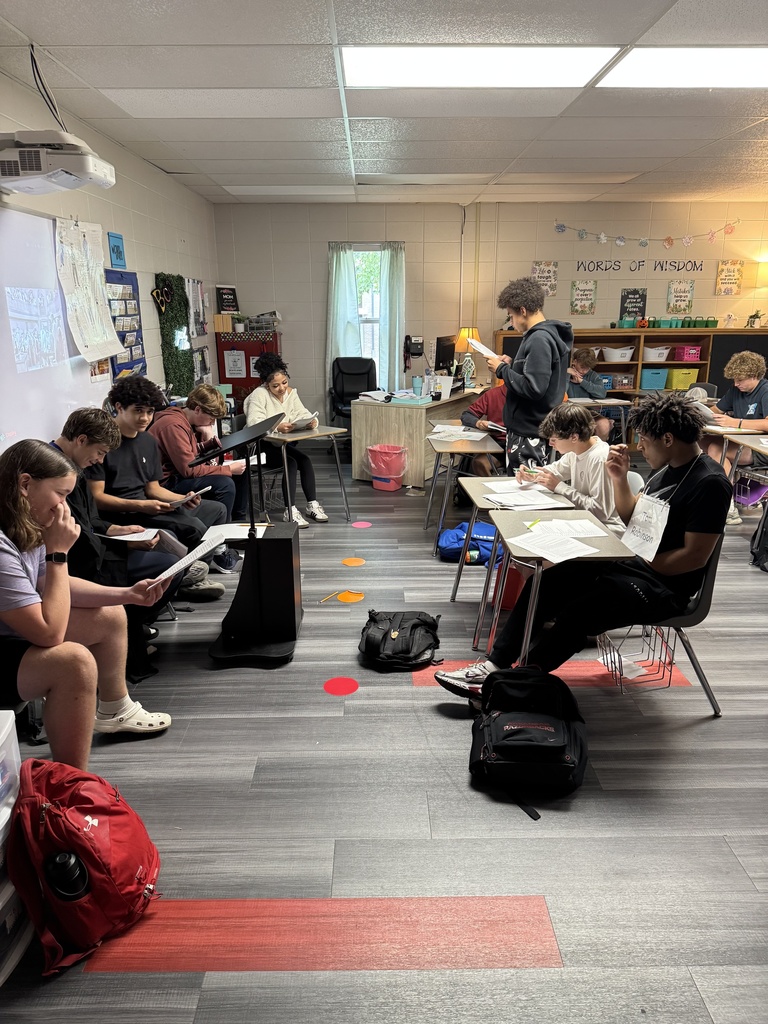 Students acting out a scene from a book in English class