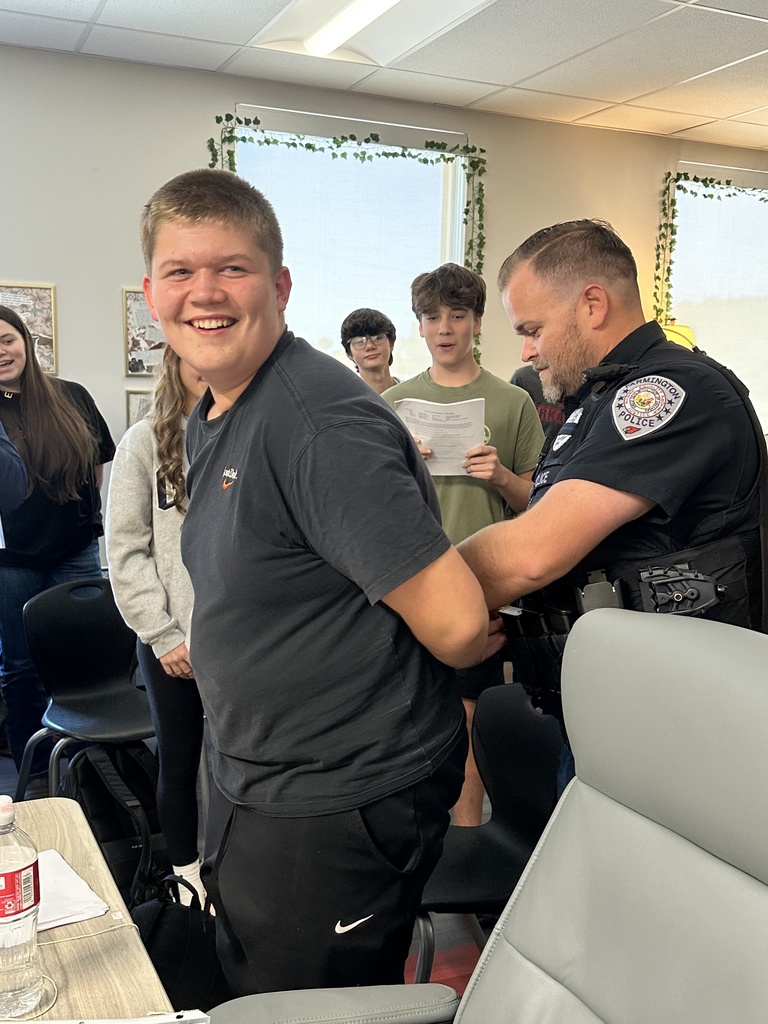 A student being "arrested" as part of their reenactment of TKAM