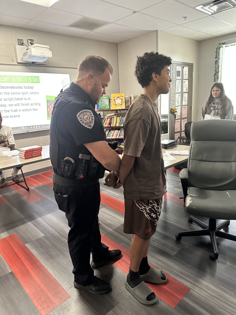 A student being "arrested" as part of their reenactment of TKAM