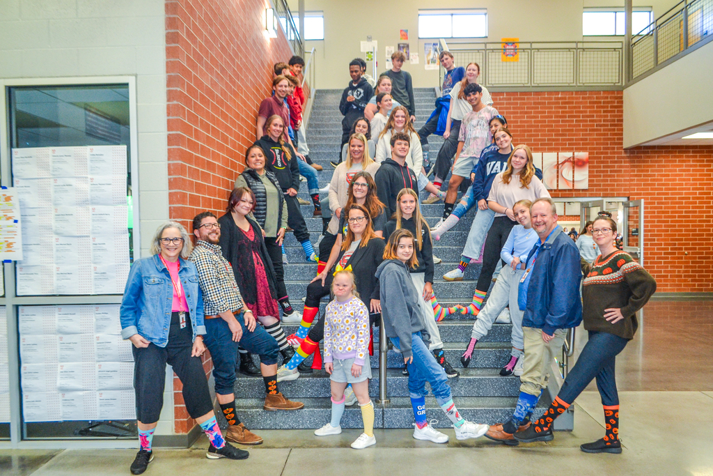students and teachers posing with crazy socks