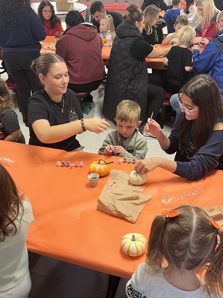 FJHS Students helping pre-k student paint pumpkin