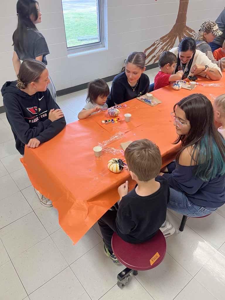 FJHS Students helping pre-k student paint pumpkin