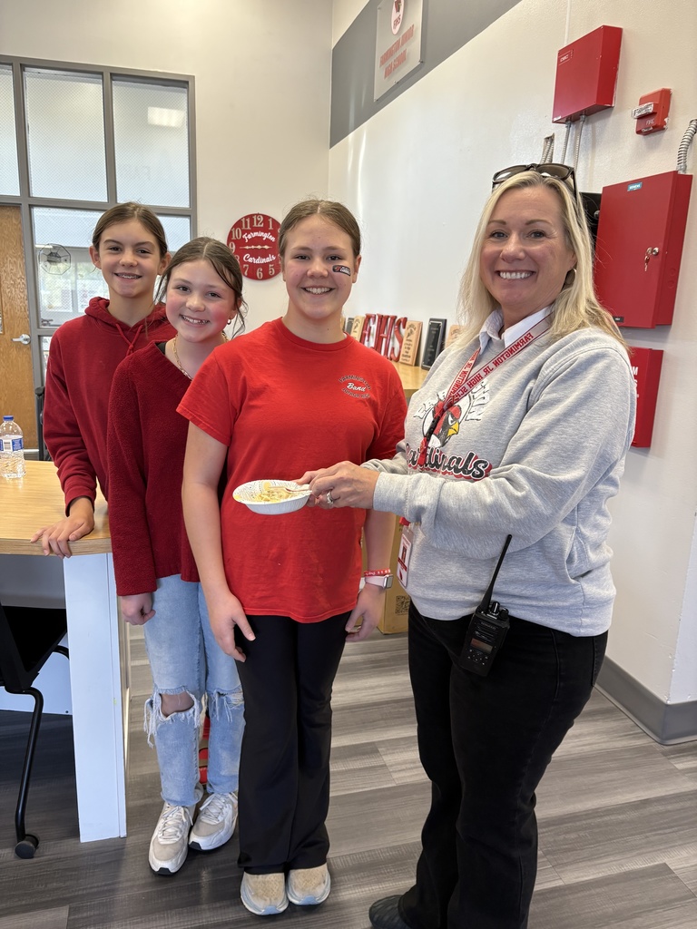 Students giving Dr. Morris a bowl of pasta