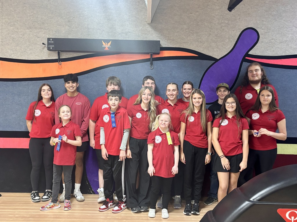 students posing with banner