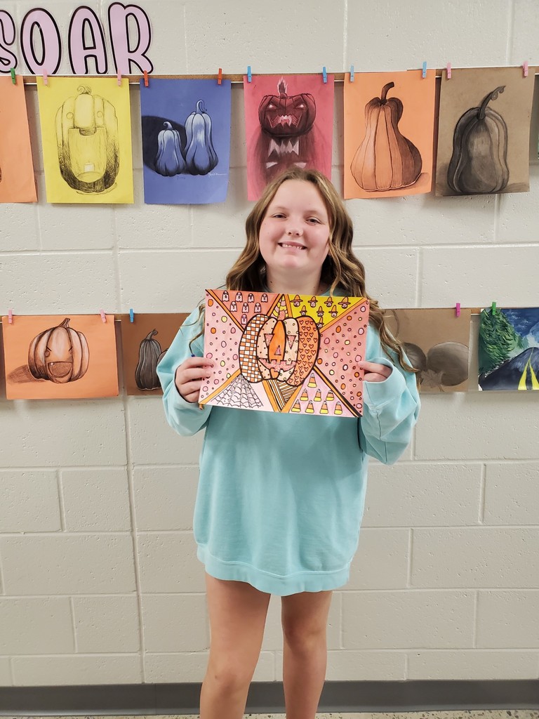 Student shows off her pumpkin art