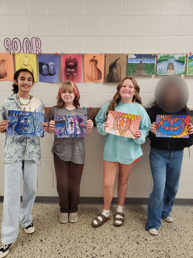 Students show off their pumpkin art
