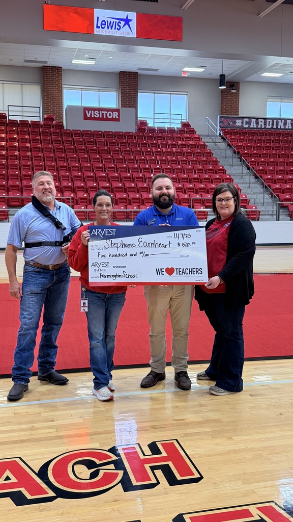 personnel posing with giant check