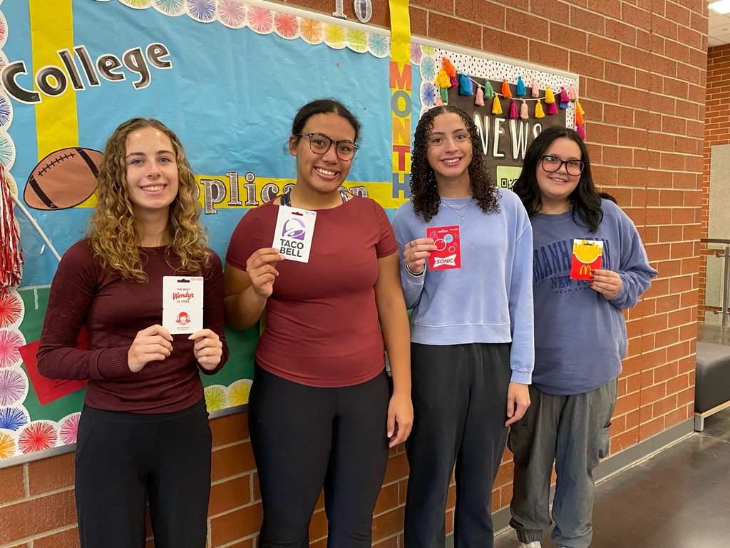 picture of students posing with gift cards