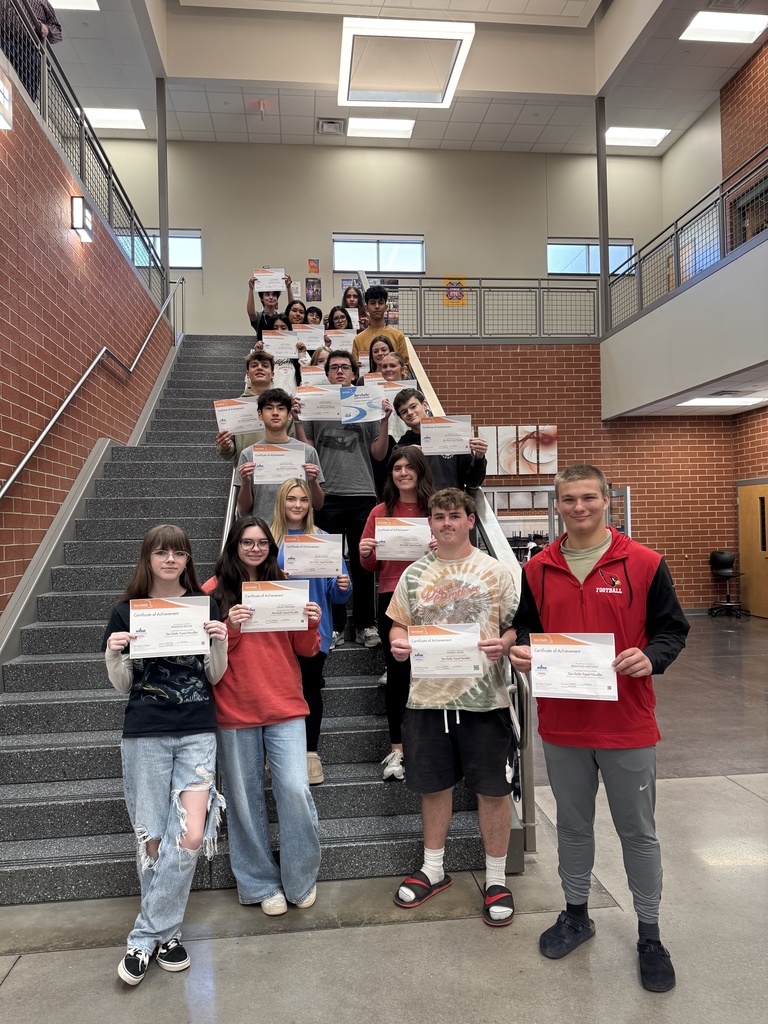students posing with certificates