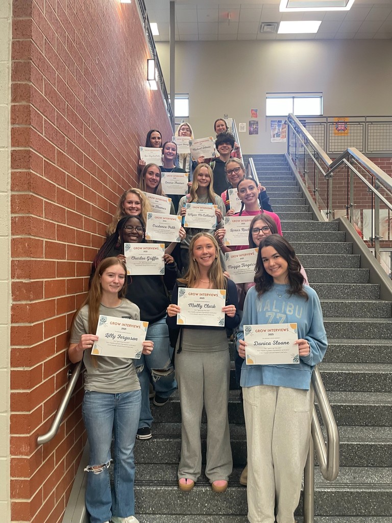 students posing with certificates
