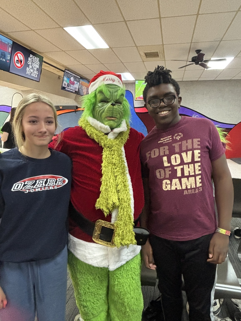 students posing with grinch