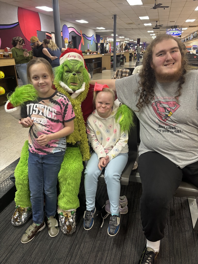 students posing with grinch