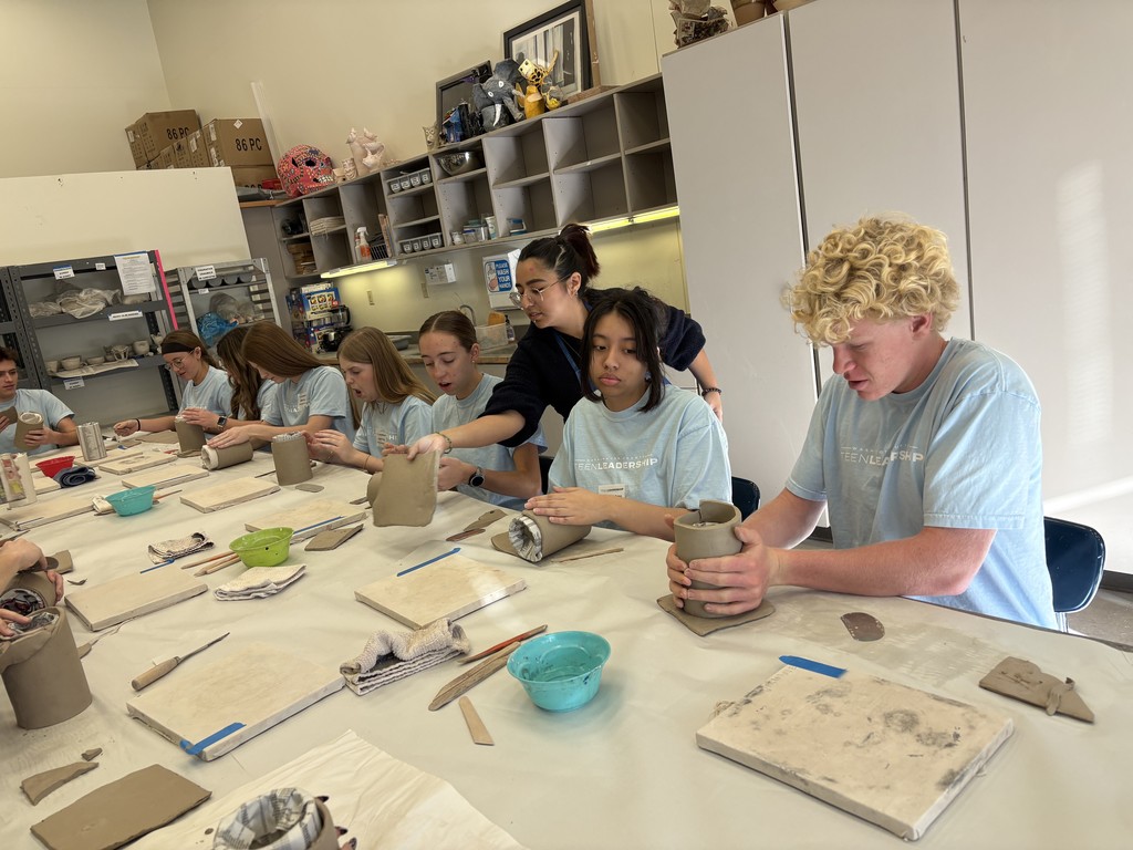 students making pottery