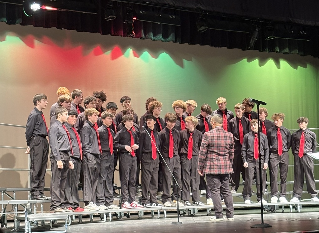 Members of the Jr. High choir on stage performing at a concert