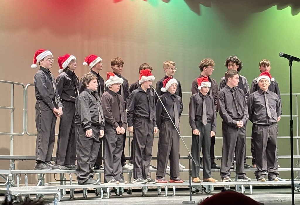 Members of the Jr. High choir on stage performing at a concert