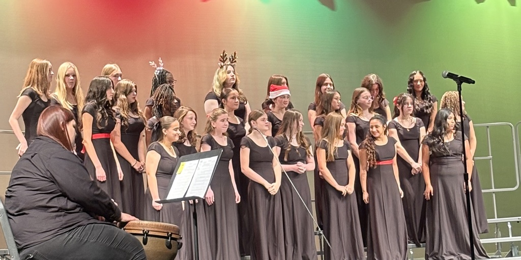 Members of the Jr. High choir on stage performing at a concert