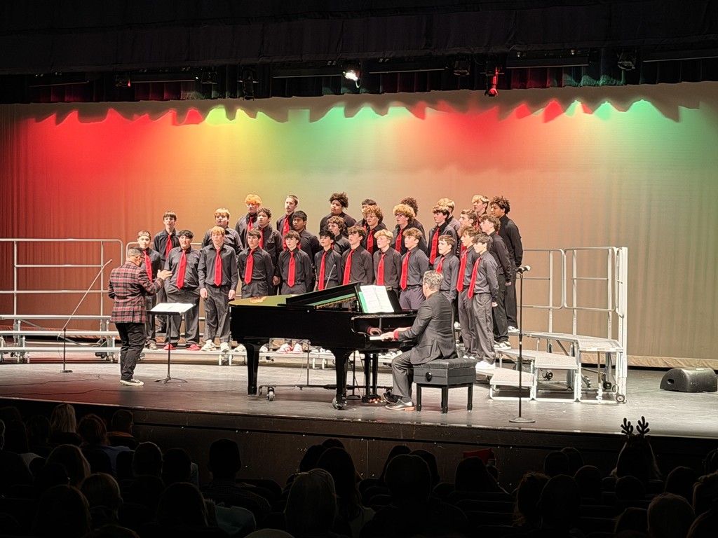Members of the Jr. High choir on stage performing at a concert