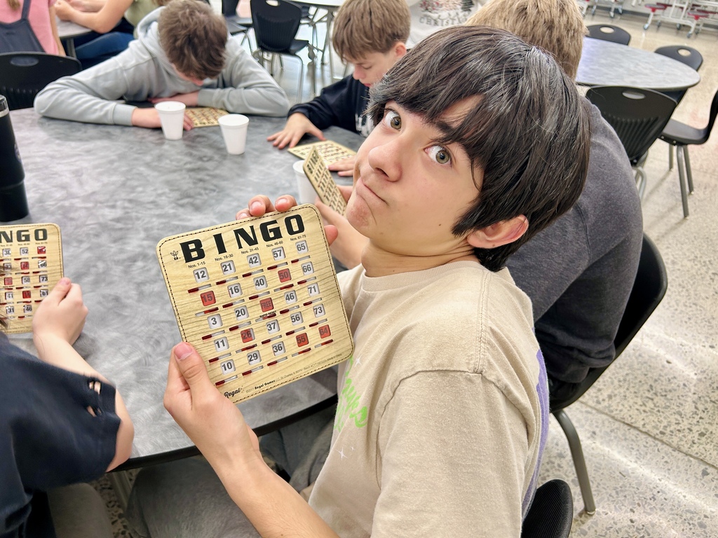 Student showing BINGO card at Reward Day