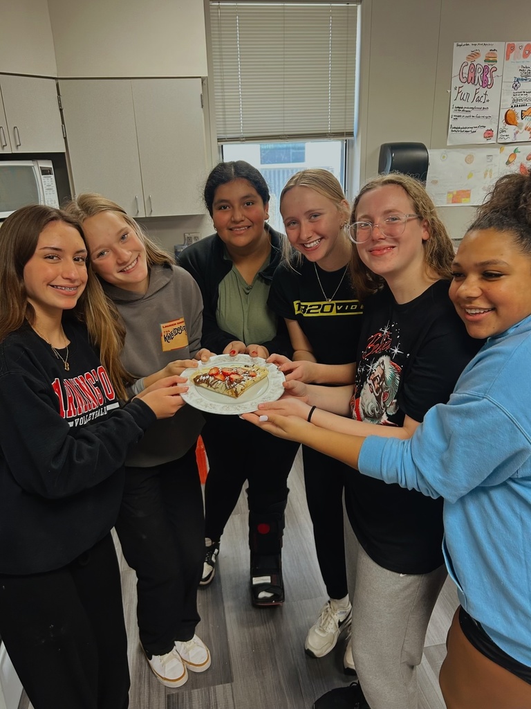 Students holding a dessert they made in FACS