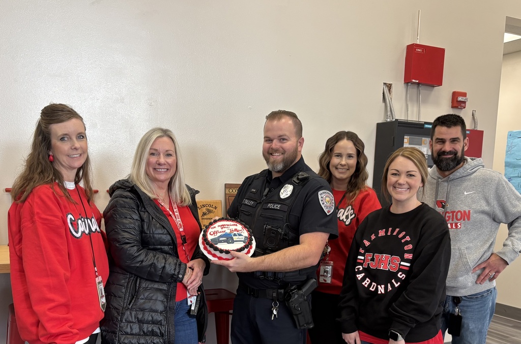 Officer Talley with office staff, holding cake