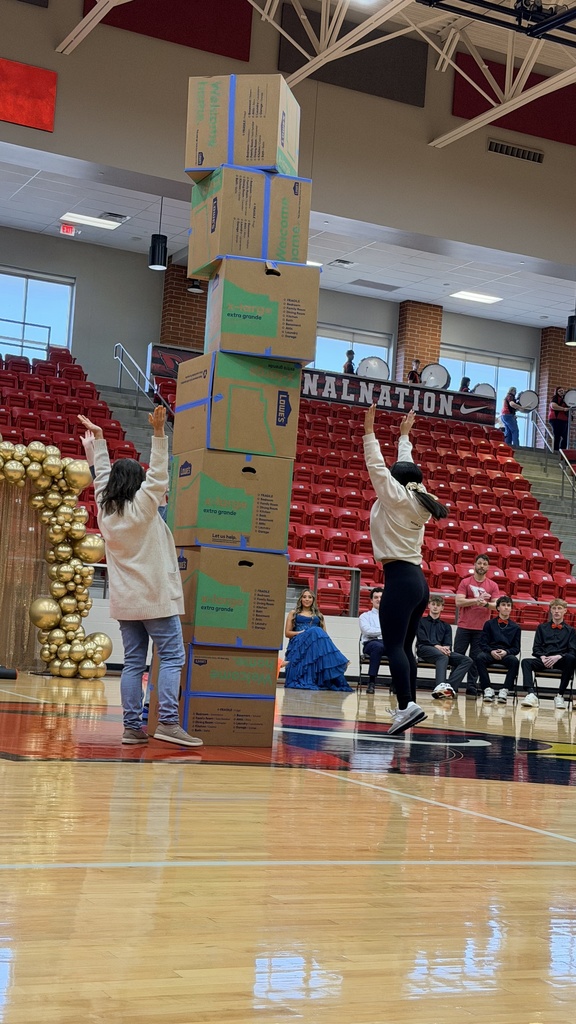 students and teachers stacking boxes on court