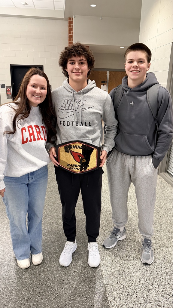 students and teacher posing with competition belt