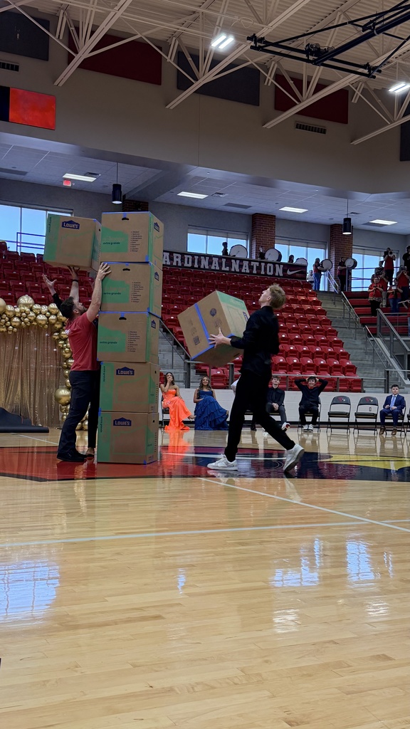 students and teachers stacking boxes on court