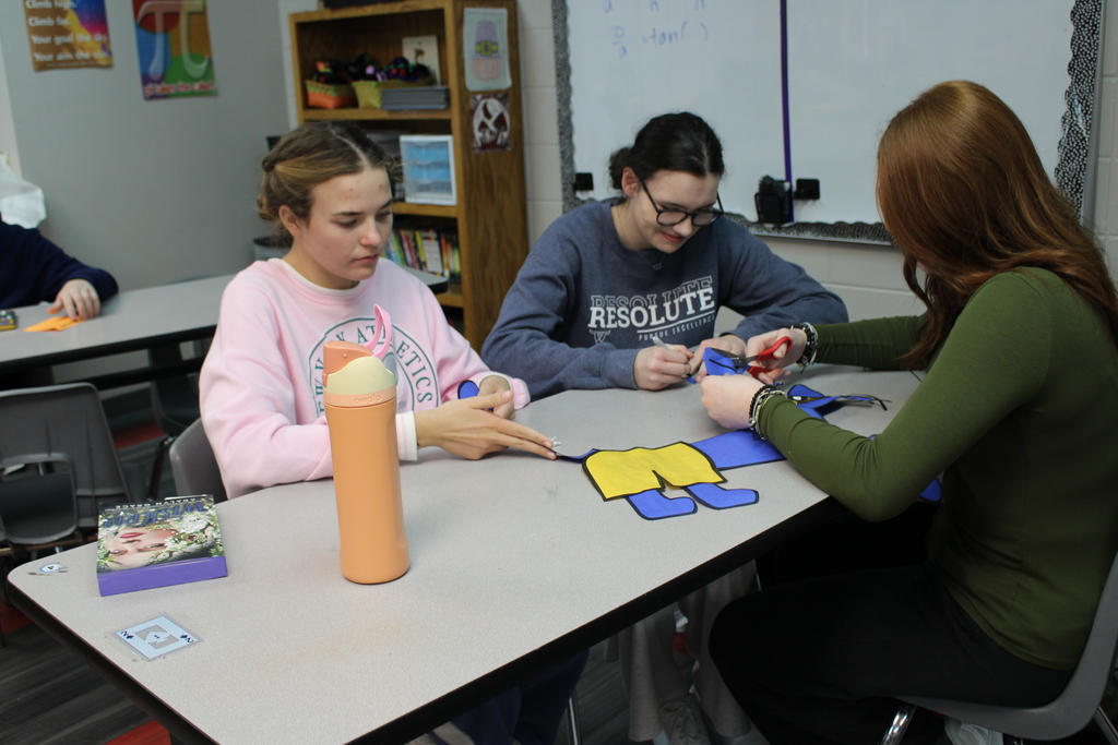 girls working on cutting stuff out
