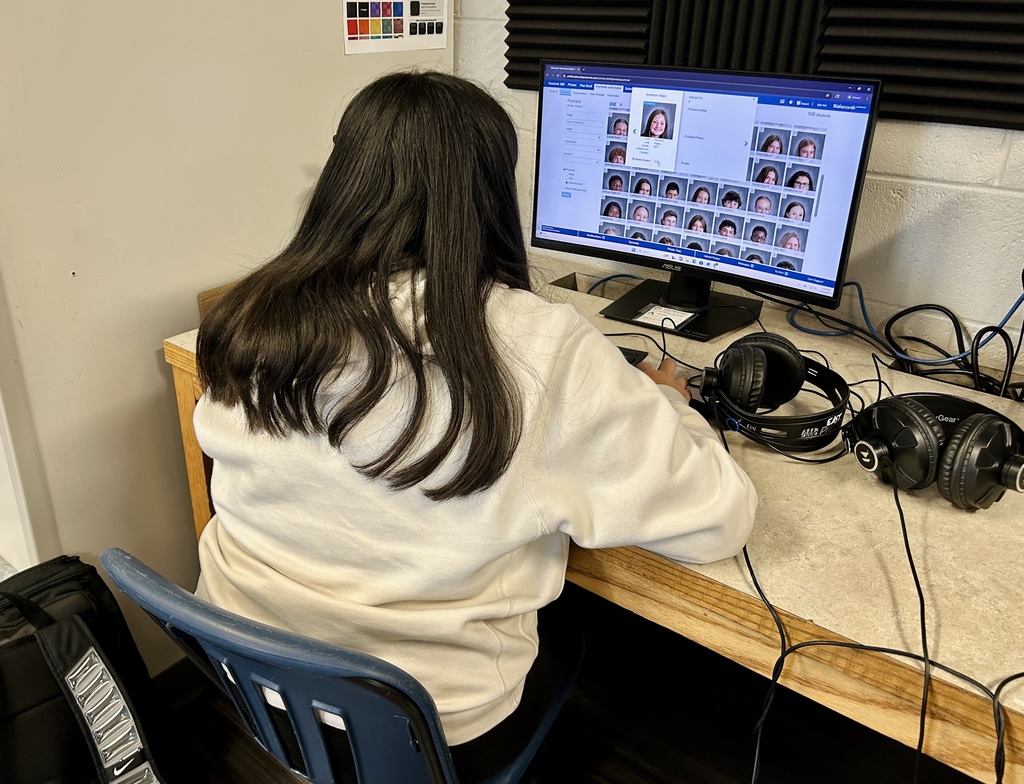 Yearbook students working on the computer