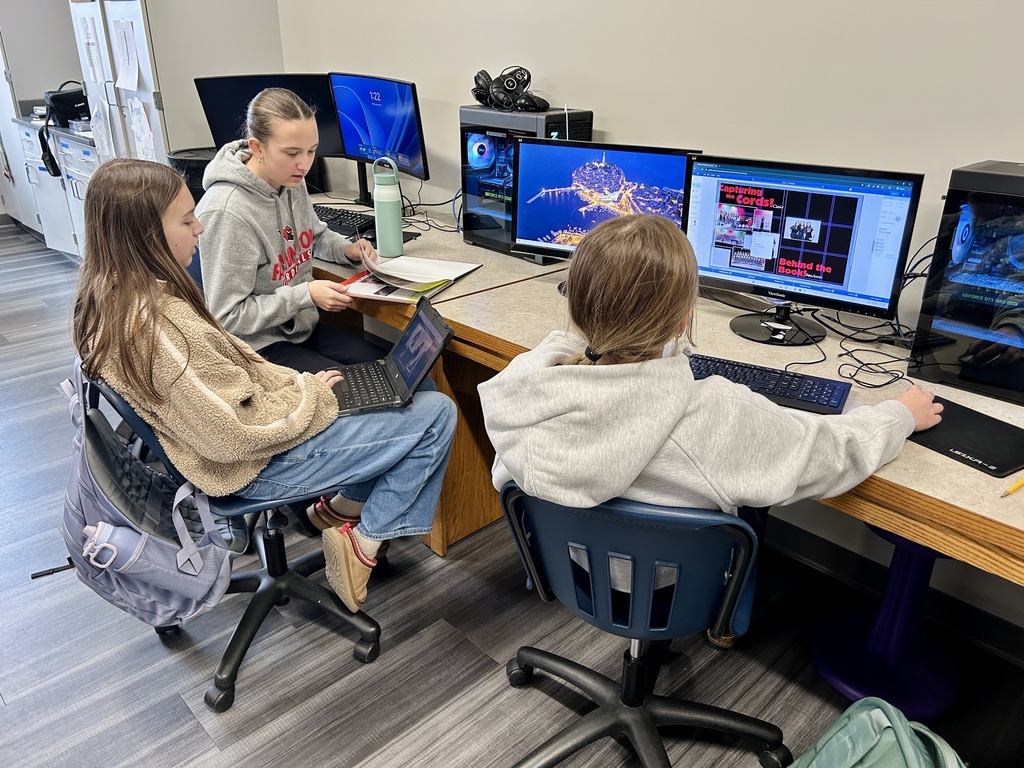 Yearbook students working on the computer