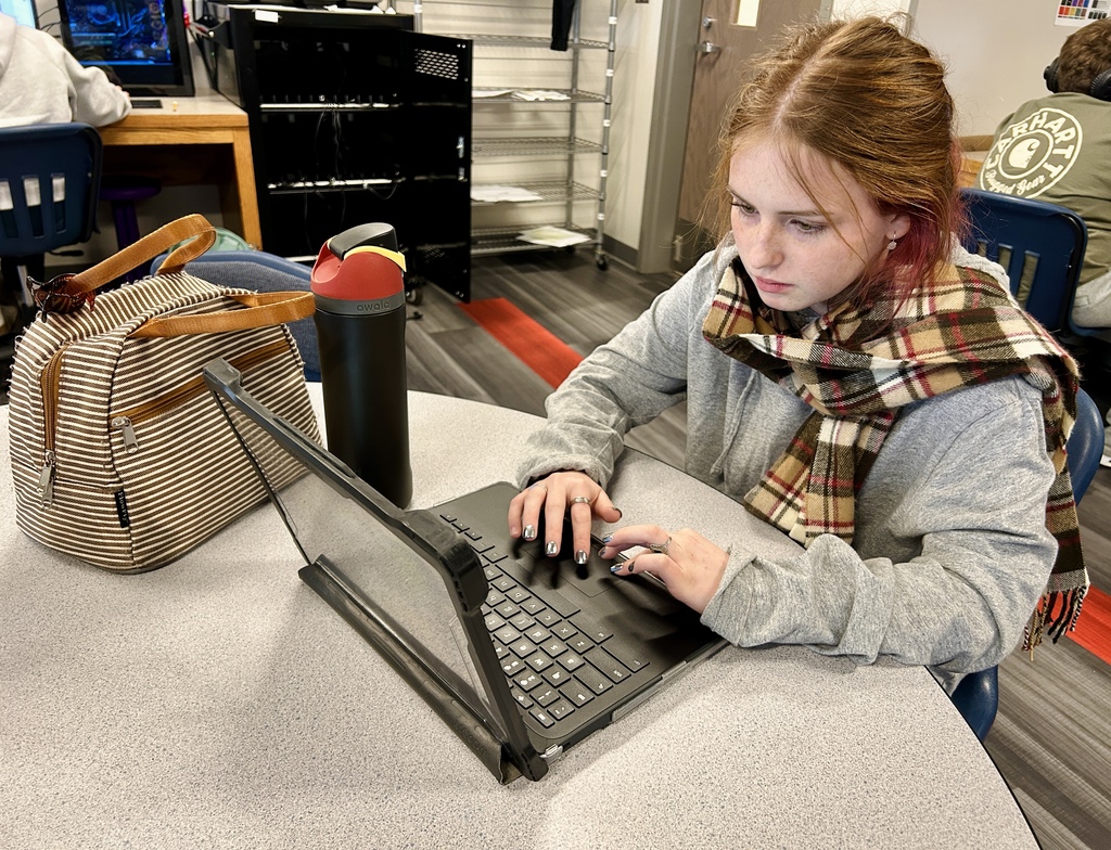 Yearbook students working on the computer
