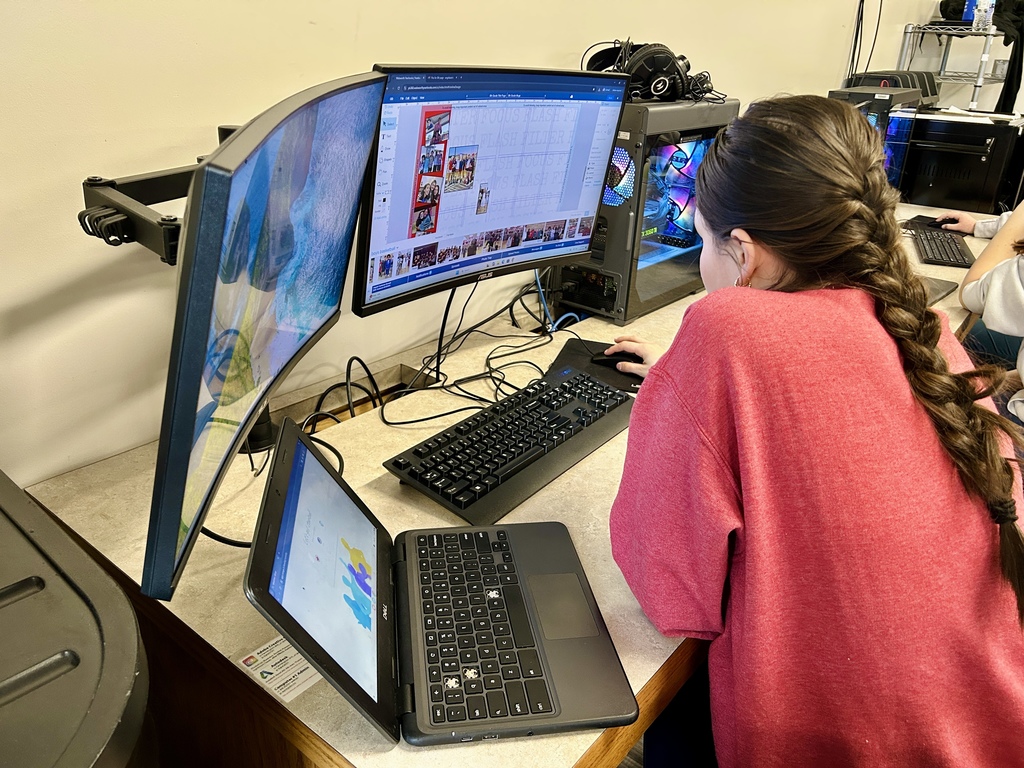 Yearbook students working on the computer