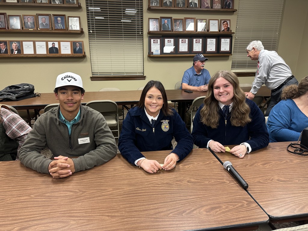students sitting at a desk posing