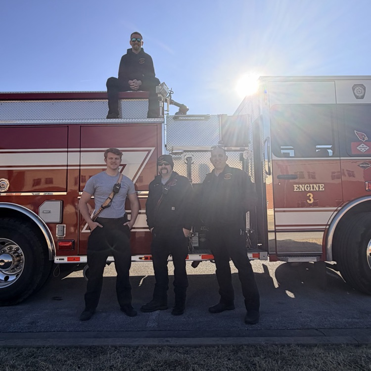 fire fighters in front of truck 