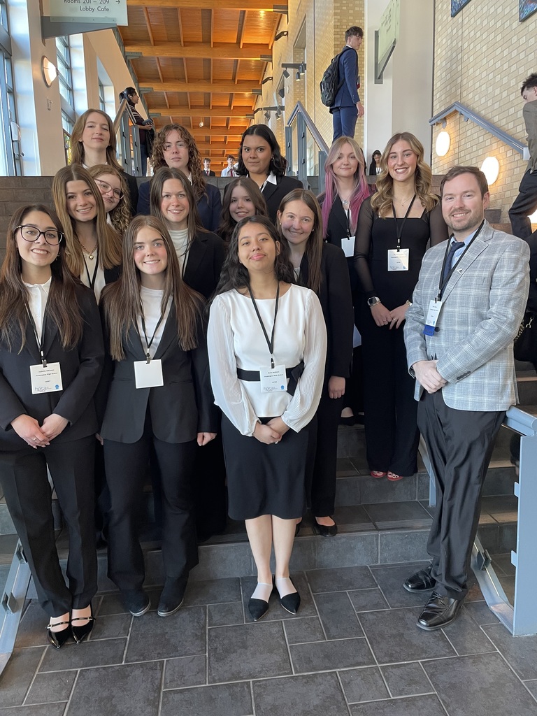 students posing on staircase