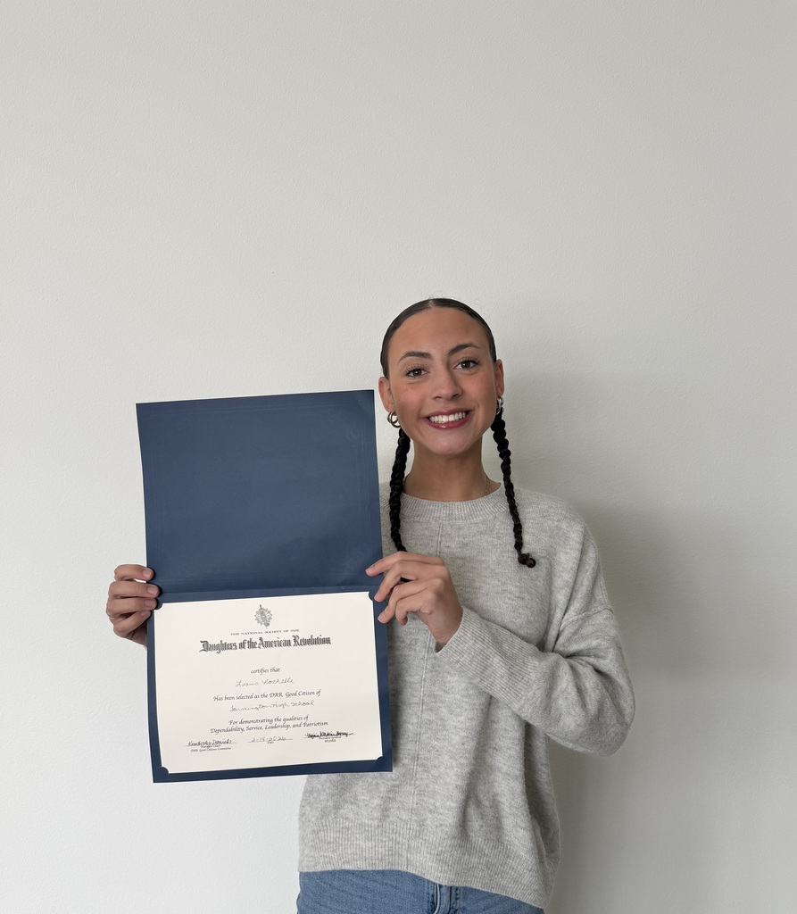 student posing with certificate