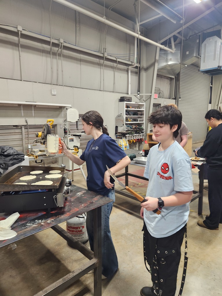 students cooking pancakes