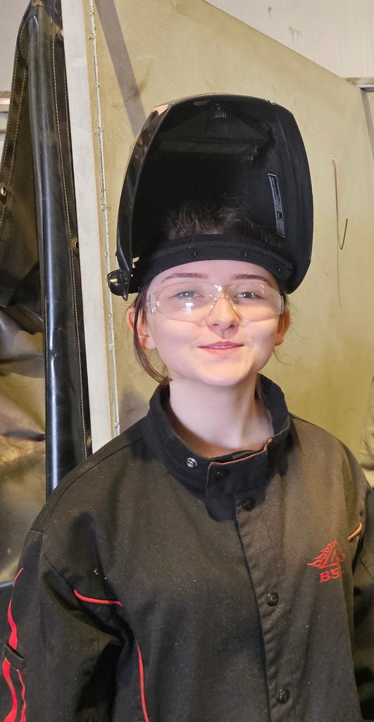 student in welding helmet
