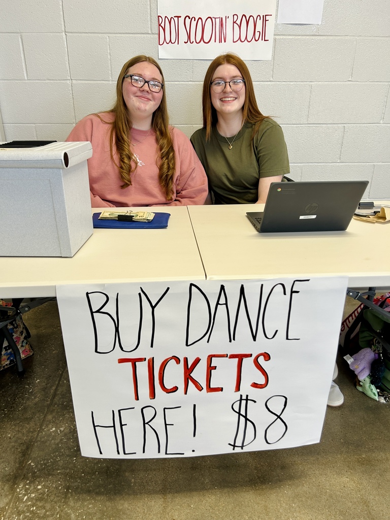 Students at the ticket table, smiling