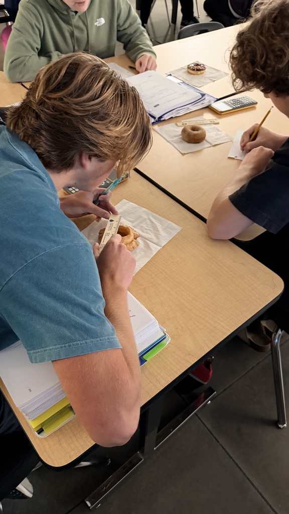 student measuring a donut