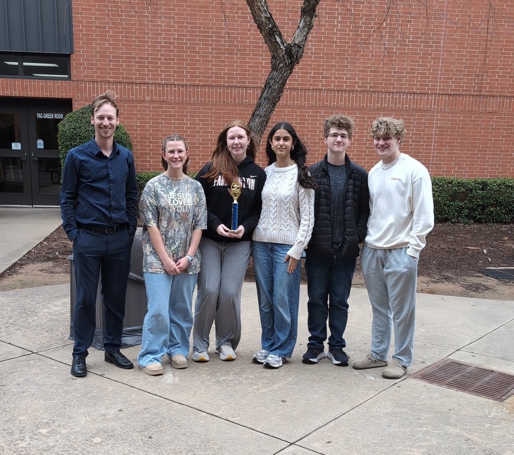 students posing with trophy