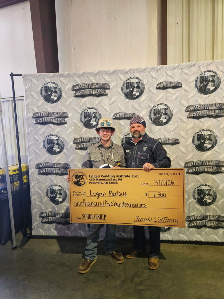 student posing with check