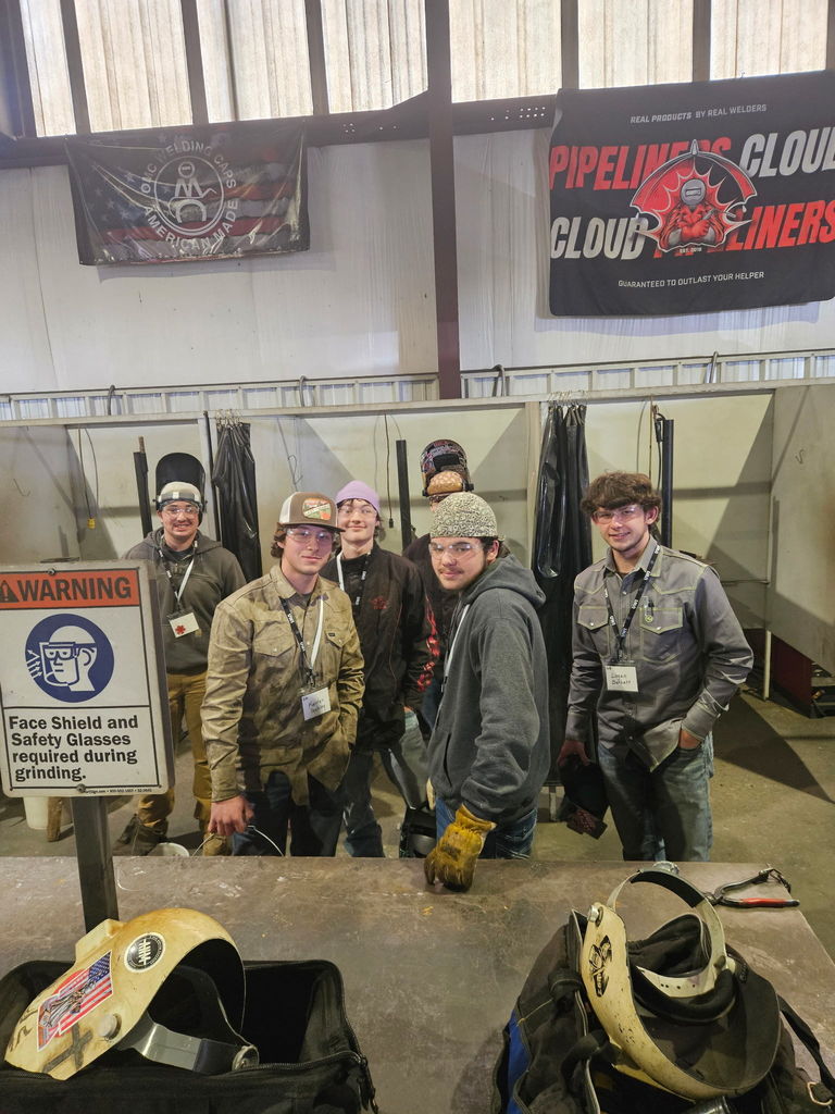 students posing in gear