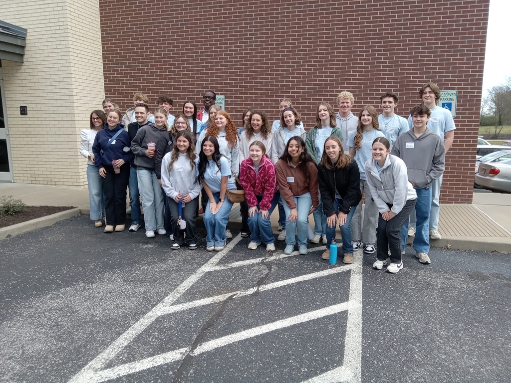 students posing outside a building 