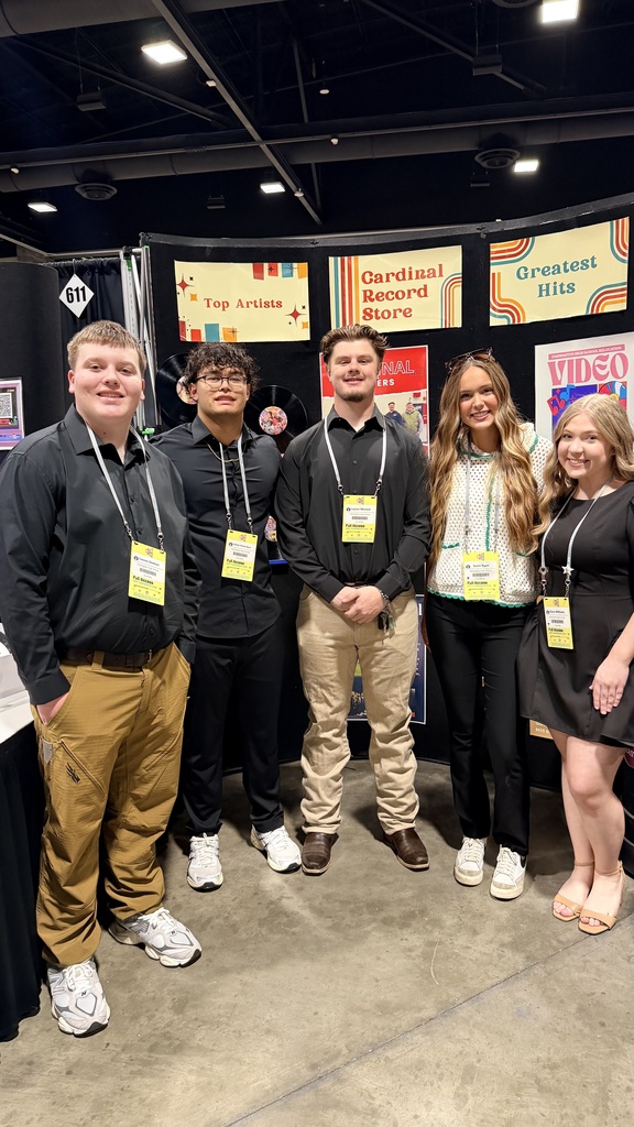 students posing in booth