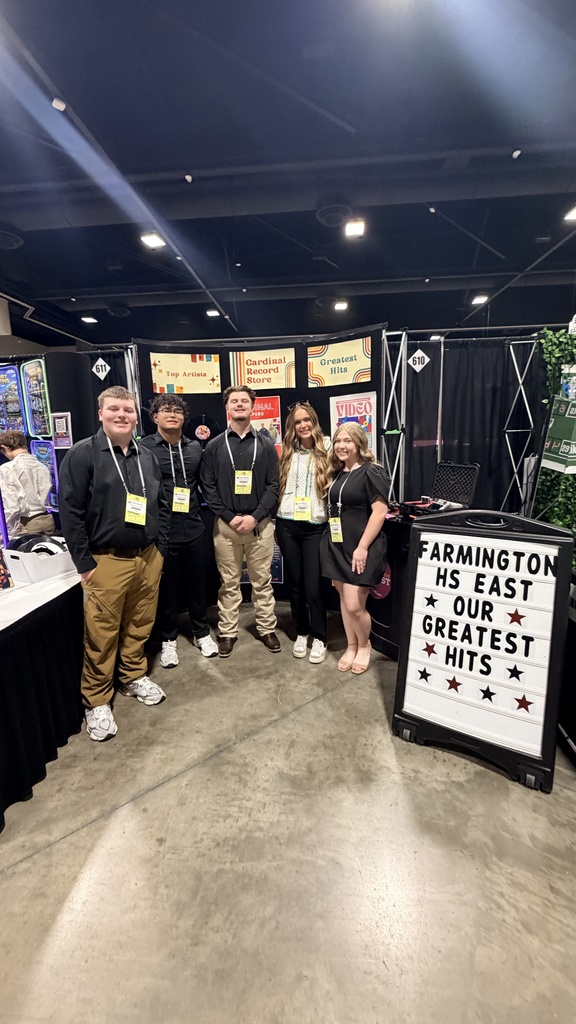 students posing in booth