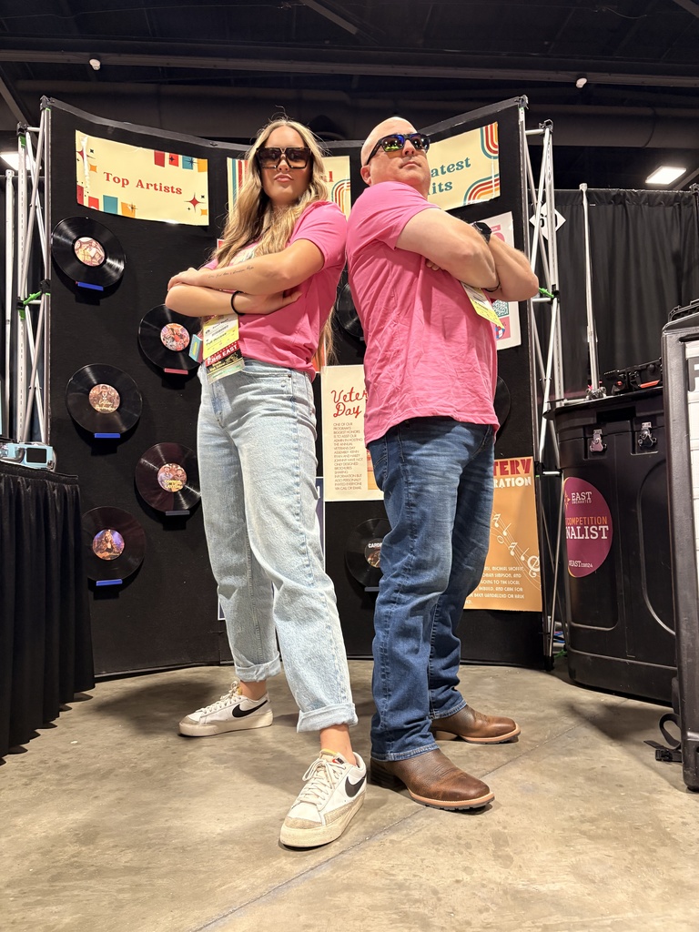 advisor and student posing in booth