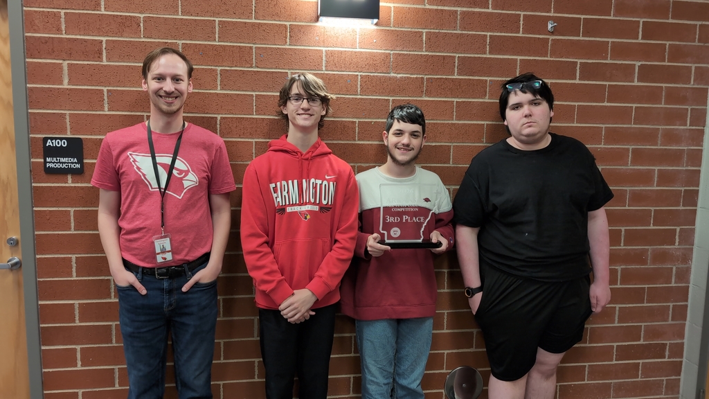 students posing with trophy