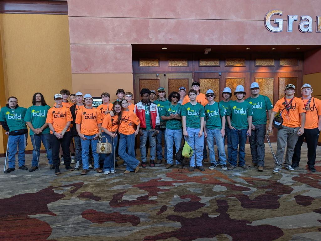 students posing outside of showcase